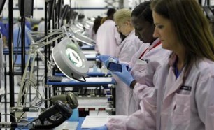 Workers assemble Motorola phones at the Flextronics plant in Fort Worth, Texas